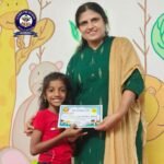 Young Girl receiving prize from Headmistress of Oliver Preschool Surathkal